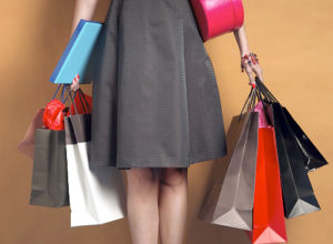 Young woman holding shopping bags and boxes, mid section Original Filename: 200282976-001.jpg Gettyimages